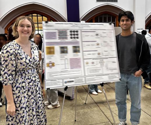 Izzy and Devin present a poster.