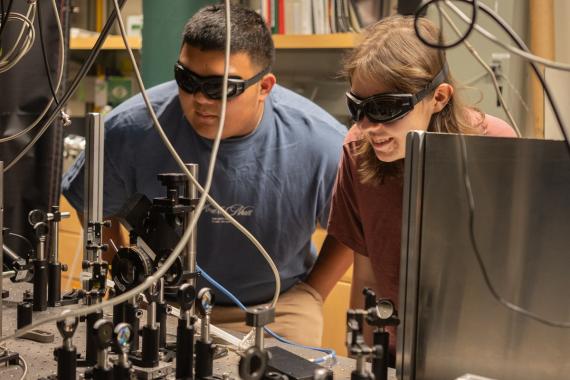 Two scientists in a laser lab.