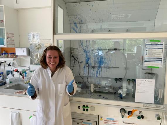 Abby Burtner gives a sheepish thumbs up after accidentally boiling a protein gel which exploded causing blue dye to splatter all over the fume hood.