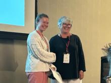Greta Jacobson receives recognition at the DMC conference