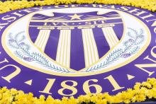 The UW Seal on a large banner surrounded by yellow flowers