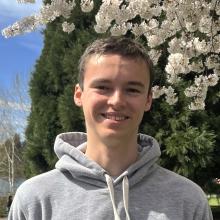 Kieran Lyons near a blossoming tree