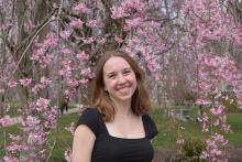 Lucy Miller poses under a flowering tree