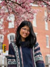 Rittika Saha under a blossoming tree