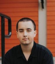Aaron Weaver with short hair wearing a dark shirt