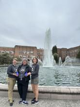 Diana Knight, Jolyn Mason, and Cassie Davis stand in front of Drumheller Fountain with Bagley Hall behind them.