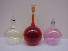 three glass bulbs of halogen gas