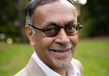 Pradip Rathod wears round glasses and a goatee