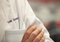 Close up shot of "UW Chemistry" embroidered in purple on a white lab coat