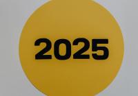 2025 paper cut out on a gold circle