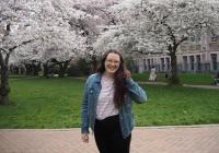 Rachel Huchmala in the Quad during the peak bloom of the cherry blossoms