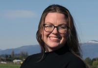 Lauren Brown stands in a field of red tulips in Skagit Valley, Washington