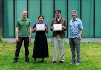 Two students pose with certificates, accompanied by CEI leadership