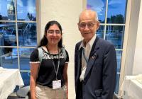 Noaman and Yoshino stand side by side.