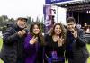 An admitted student and their parents pose with "Dubs Up" with President Ana Mari Cauce.