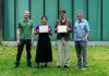 Two students pose with certificates, accompanied by CEI leadership