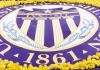 The UW Seal on a large banner surrounded by yellow flowers