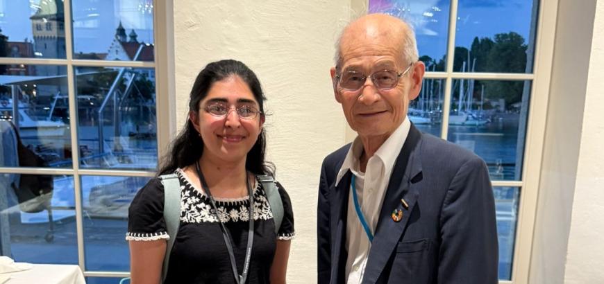 Noaman and Yoshino stand side by side.