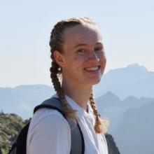 Kamaya Ronning wears her hair in two braids hiking in the mountains