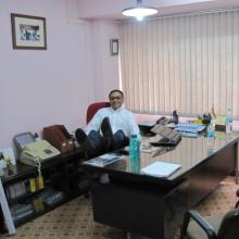 Rathod reclines at his desk